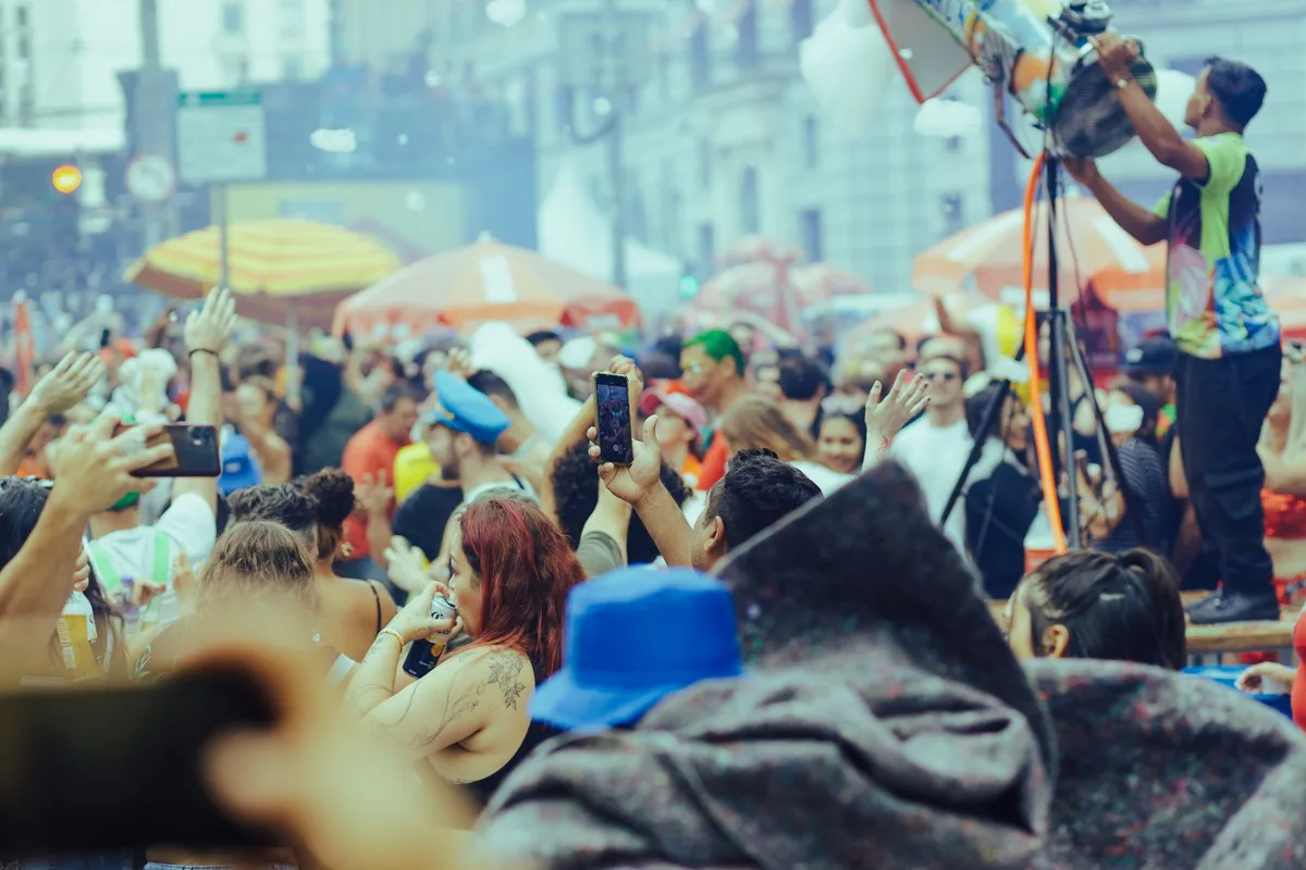 A lively street festival with a diverse crowd enjoying music and festivities outdoors.