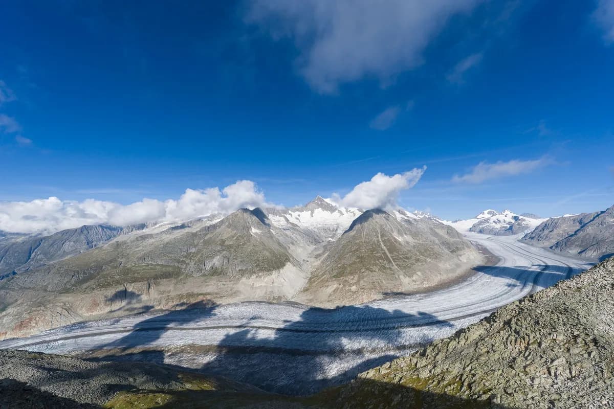 Captivating view of the Aletsch Glacier in Switzerland, surrounded by majestic mountain peaks.