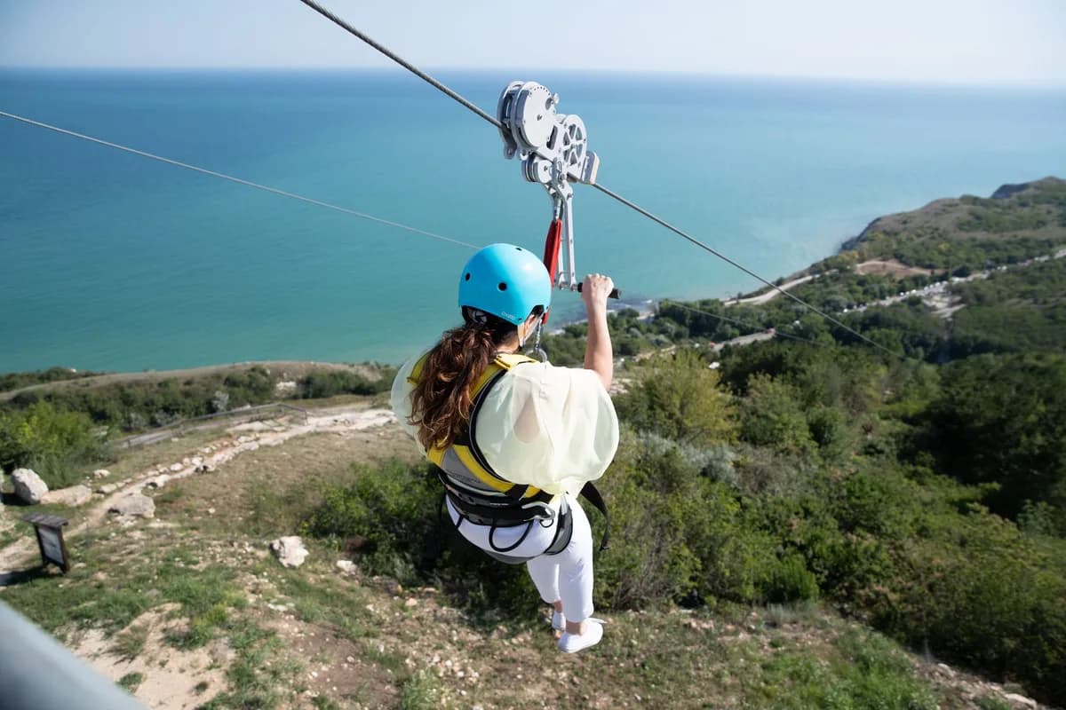Experience the thrill of ziplining over a scenic Bulgarian landscape with breathtaking sea views.