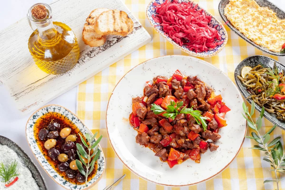 A delicious spread featuring Mediterranean dishes on a checkered tablecloth.