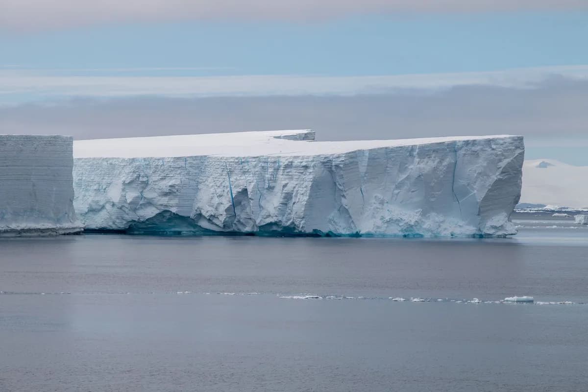 Stunning view of a massive iceberg floating in the serene Antarctic waters.