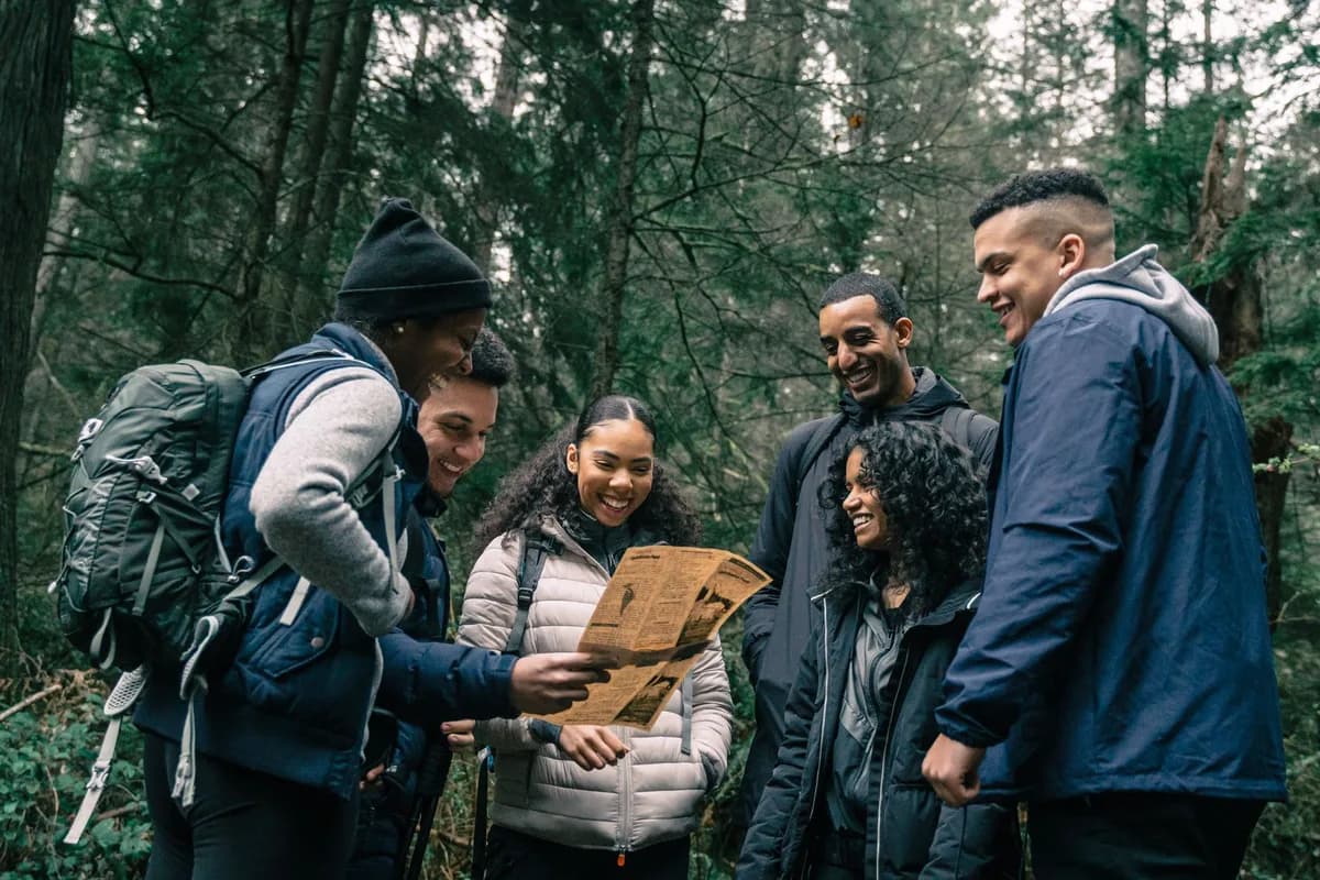 Friends navigating together on a forest hike.