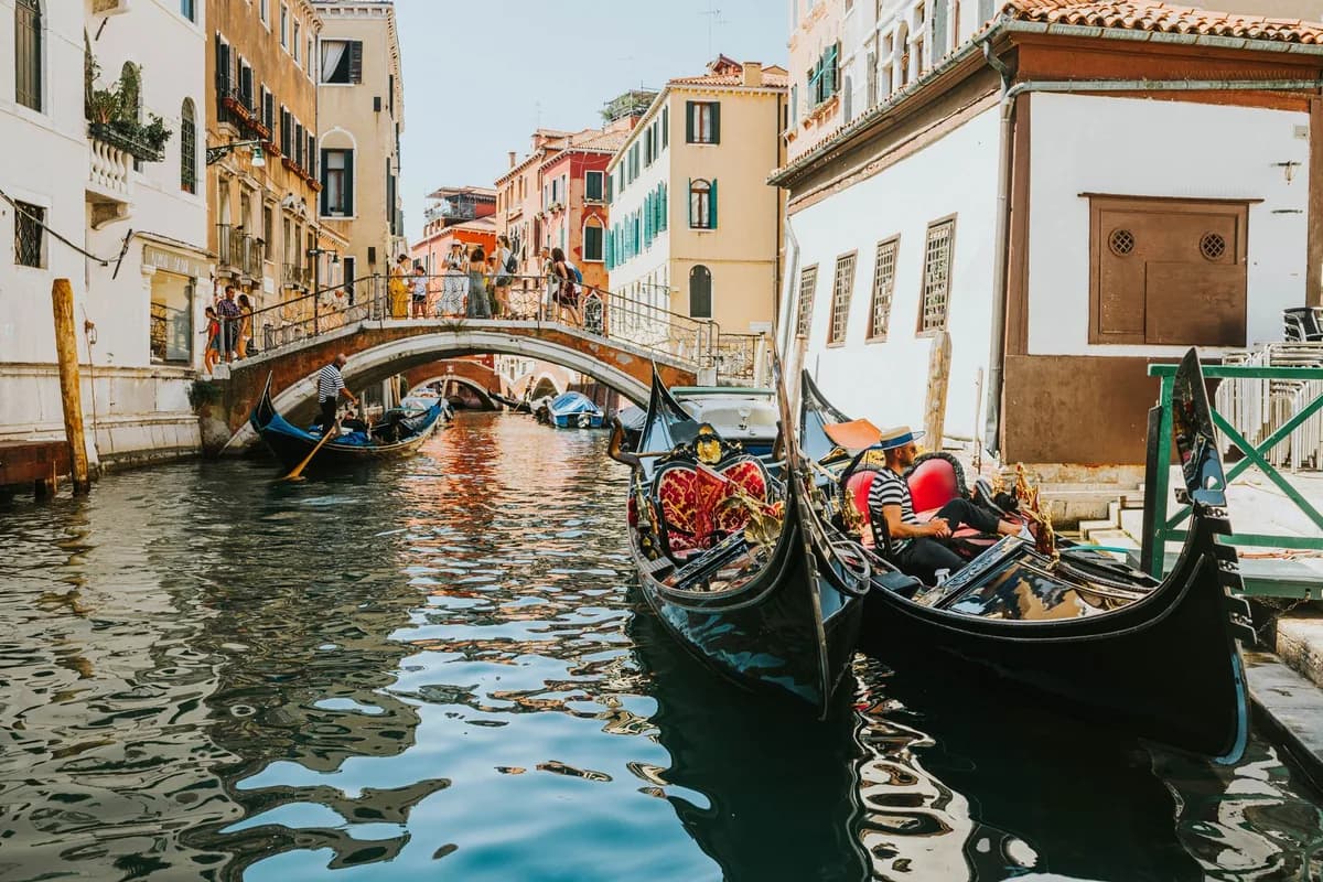 A picturesque scene of gondolas navigating a historic canal in Venice, Italy.