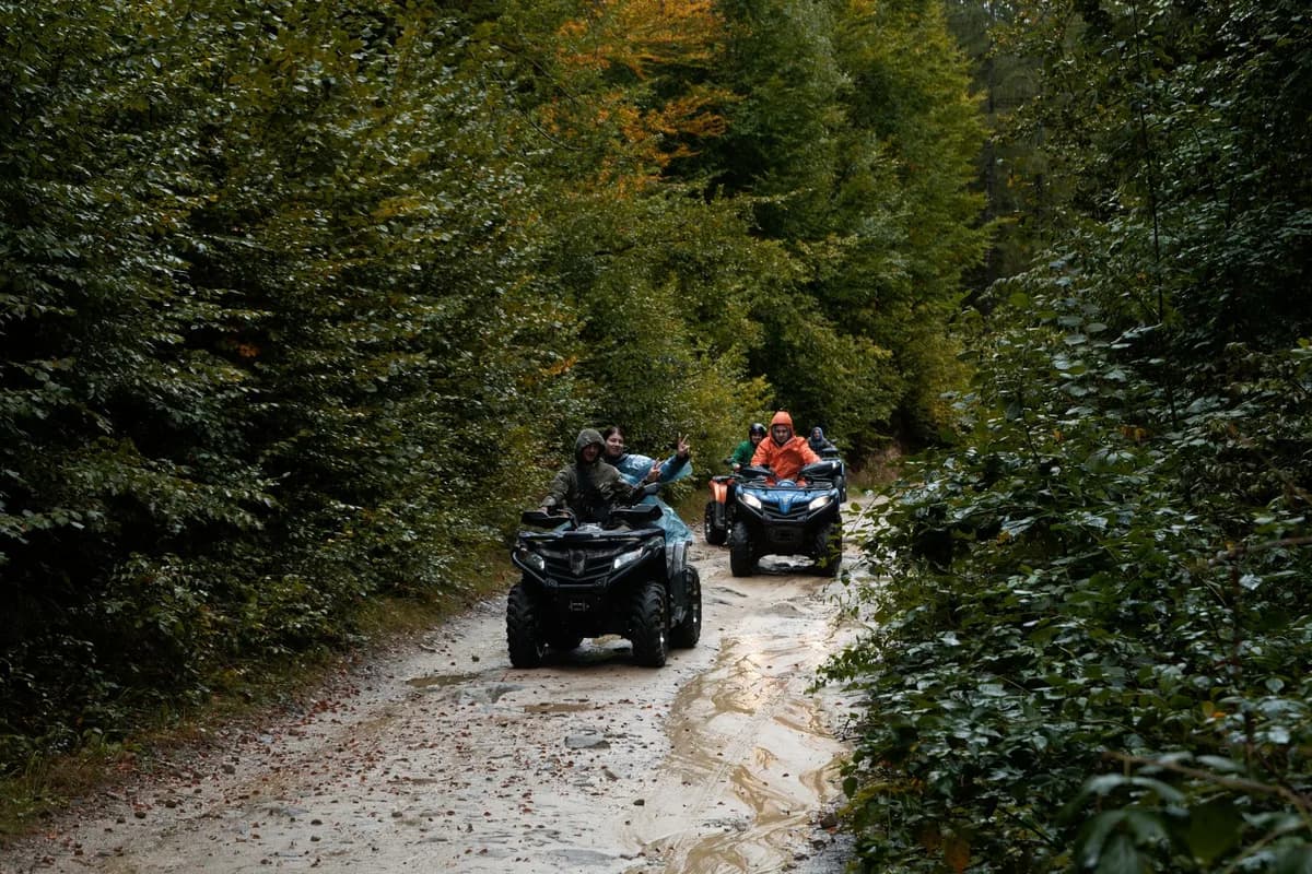 Group enjoying an adventurous ATV ride through a lush forest trail, exploring nature.