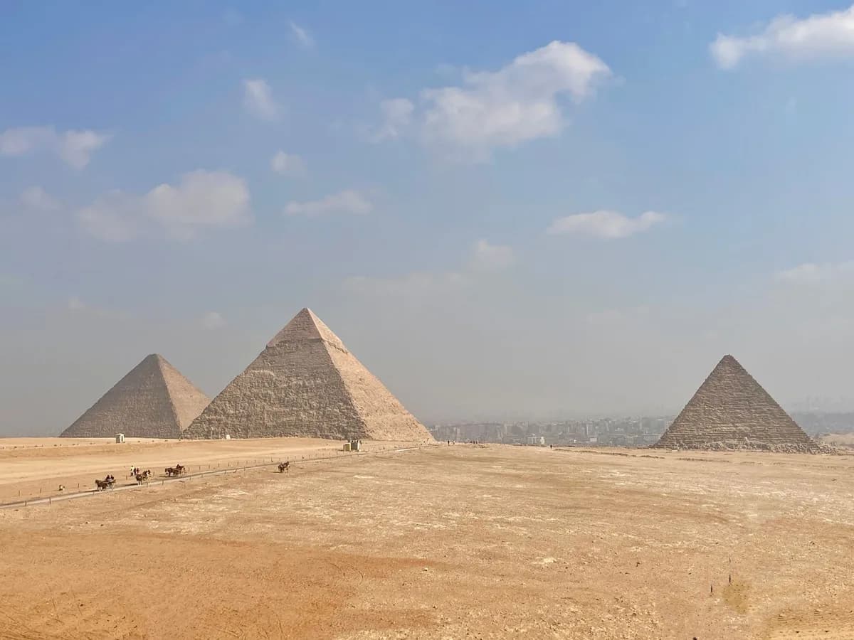 Captivating image of the iconic Pyramids of Giza with a clear sky backdrop.