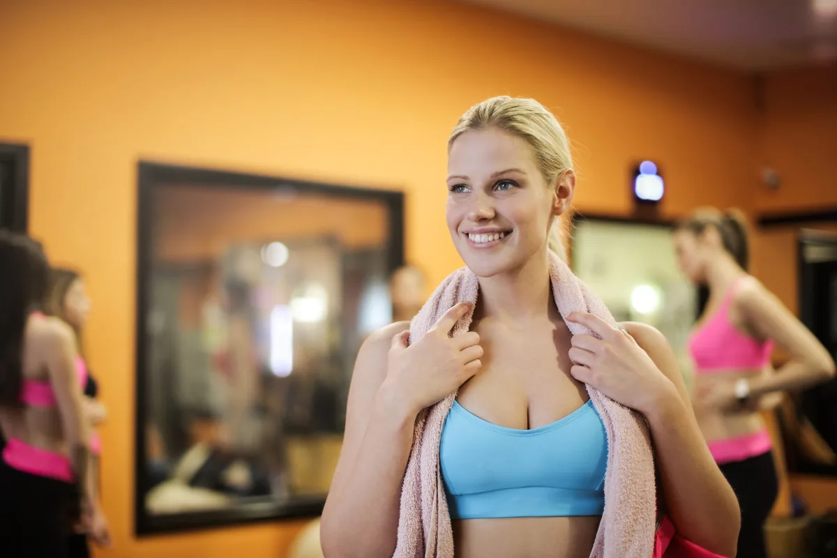 Group of women exercising indoors in a gym, reflecting healthy lifestyle and fitness.