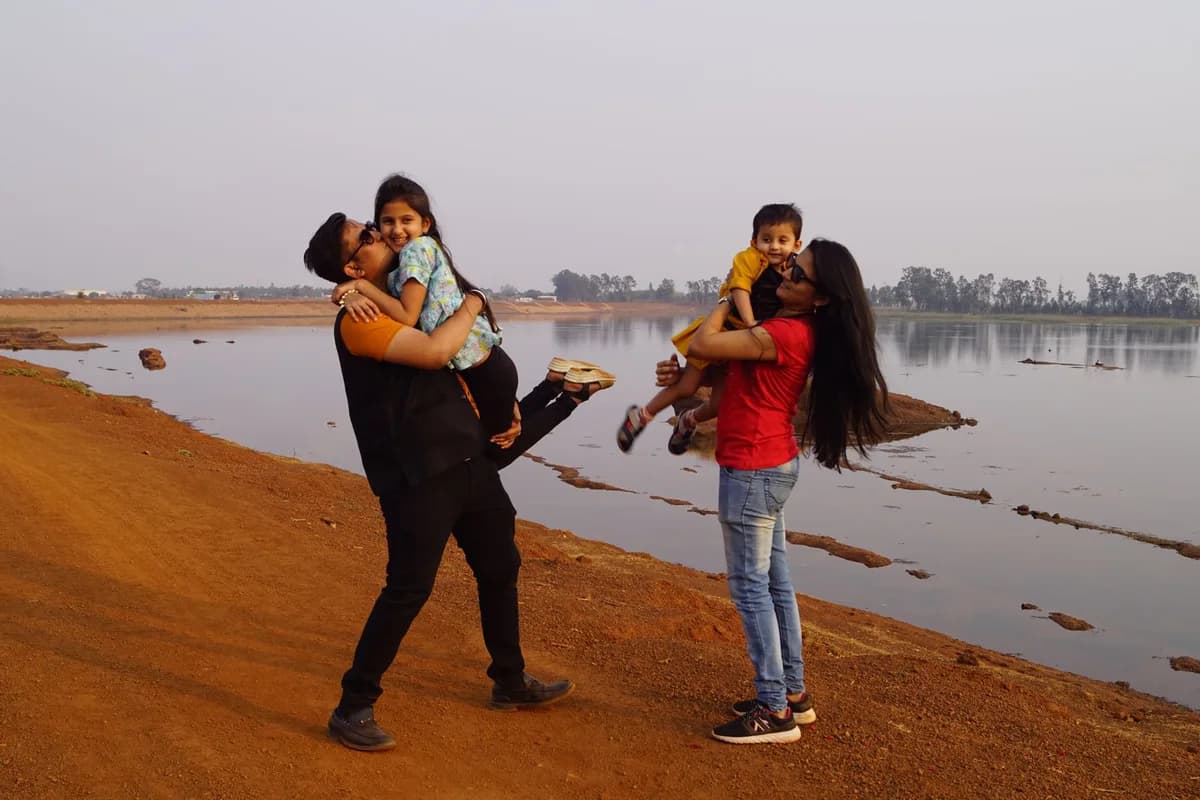 A joyful family shares quality time by a serene lakeside, creating precious memories.