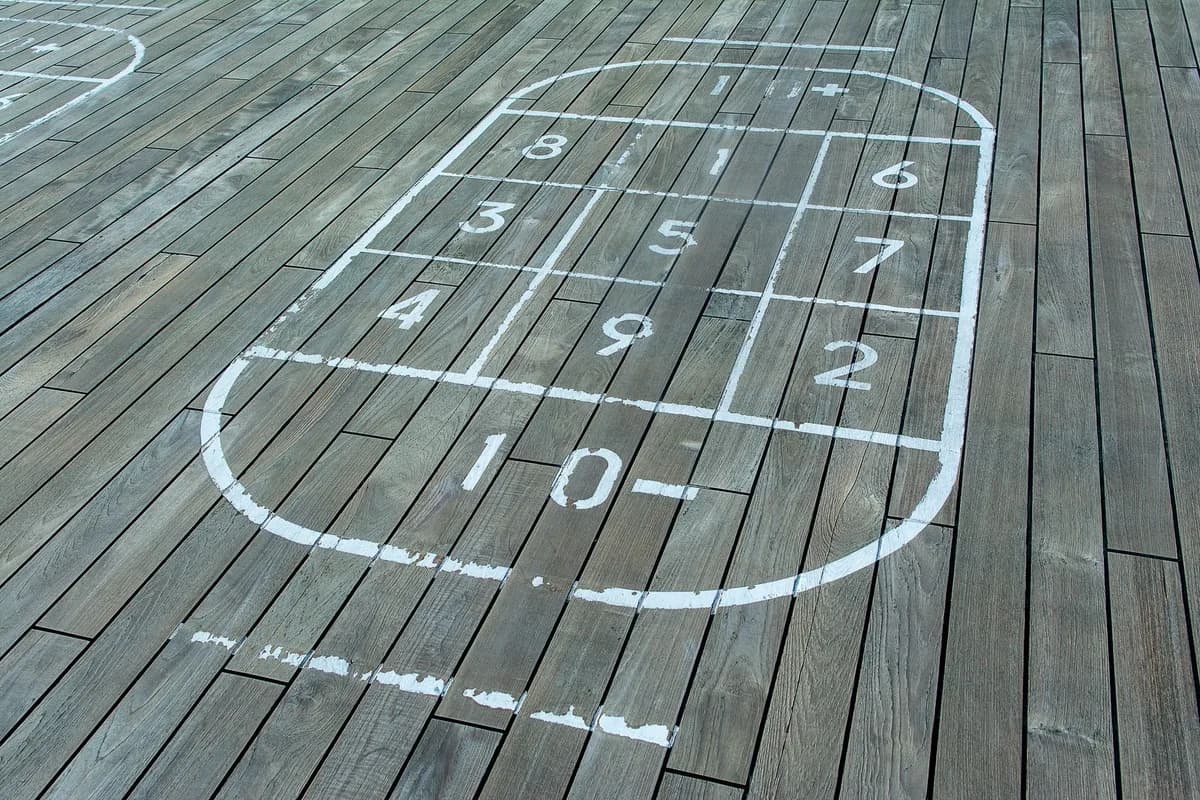 Outdoor shuffleboard court on wooden panels with numbered grid pattern for recreation and entertainment