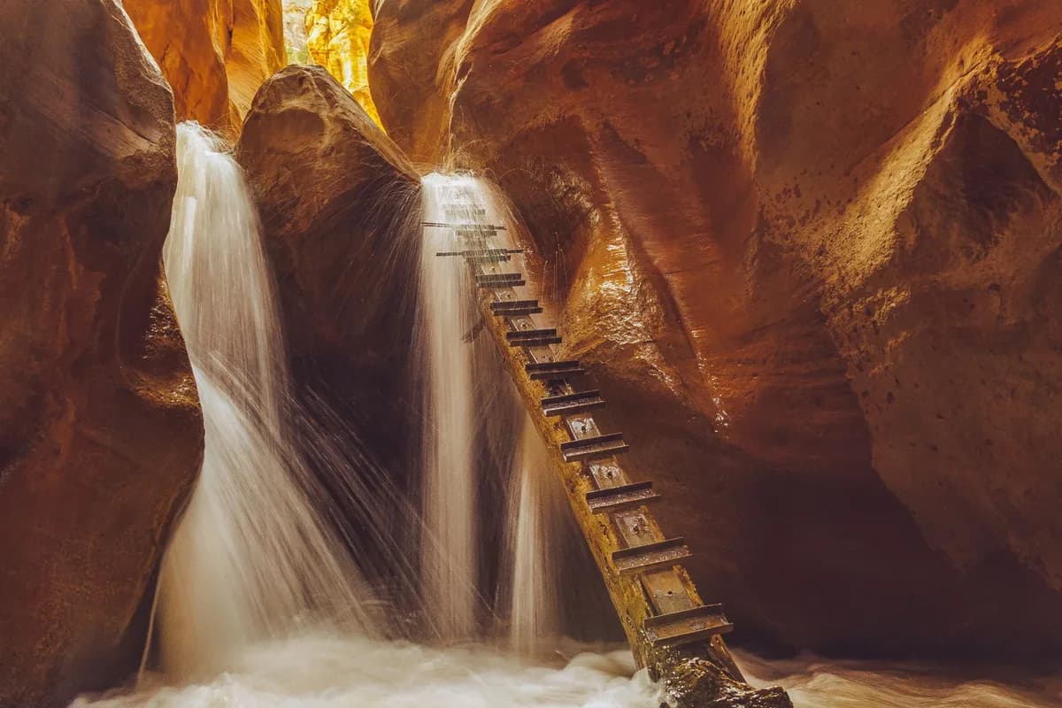 Explore the stunning Kanarra Creek waterfall with its unique ladder in a Utah sandstone canyon.