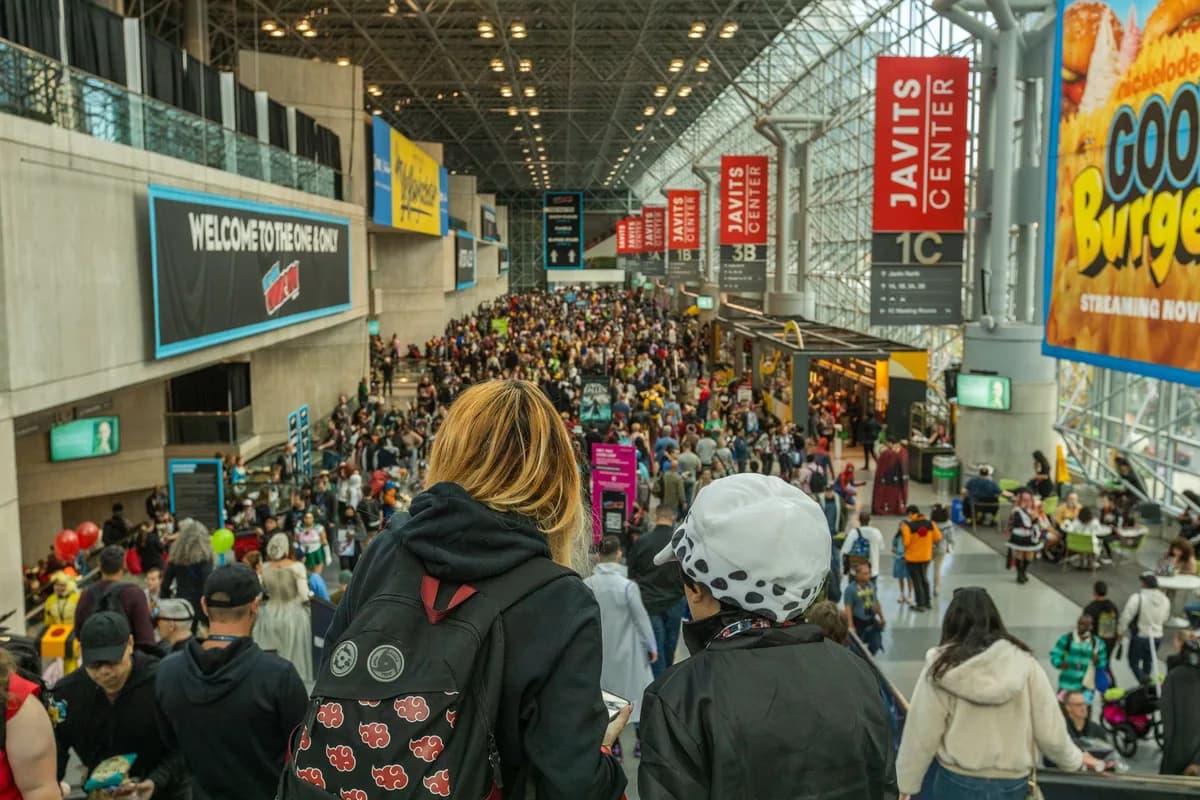 Lively crowd at New York Comic Con in Javits Center, showcasing cosplay and fan culture.