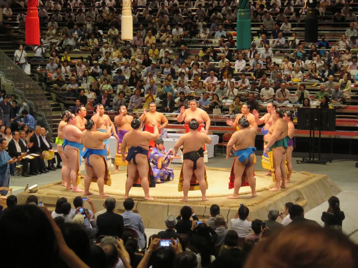 Sumo wrestlers gathered in a Tokyo arena during a traditional match.