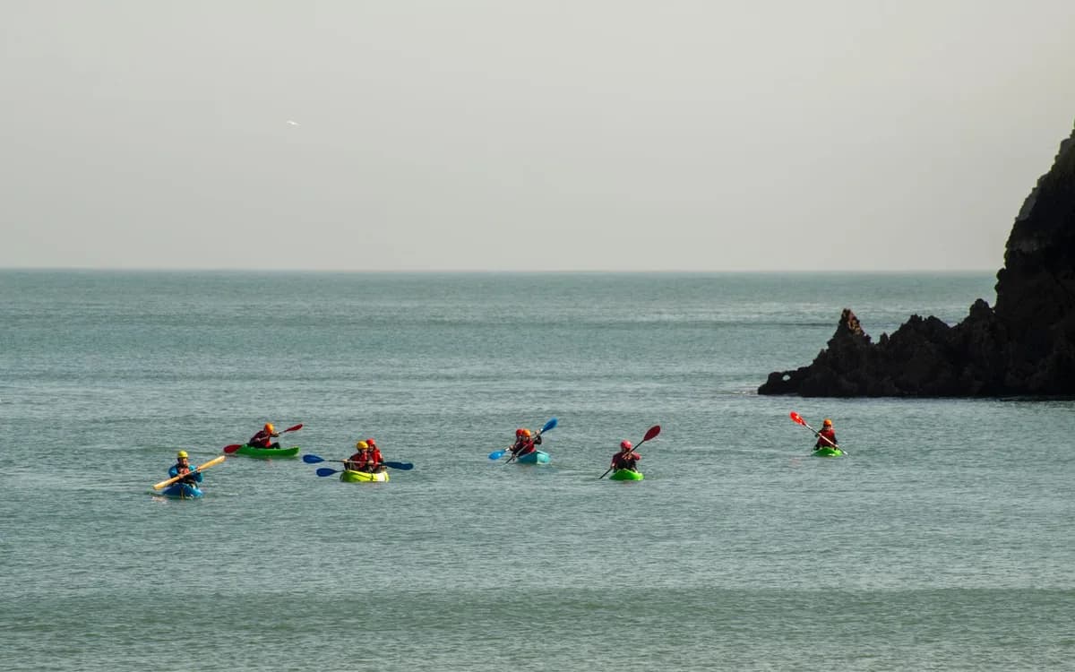 Enjoy a vibrant kayaking experience along the picturesque coastline of Wales, United Kingdom.