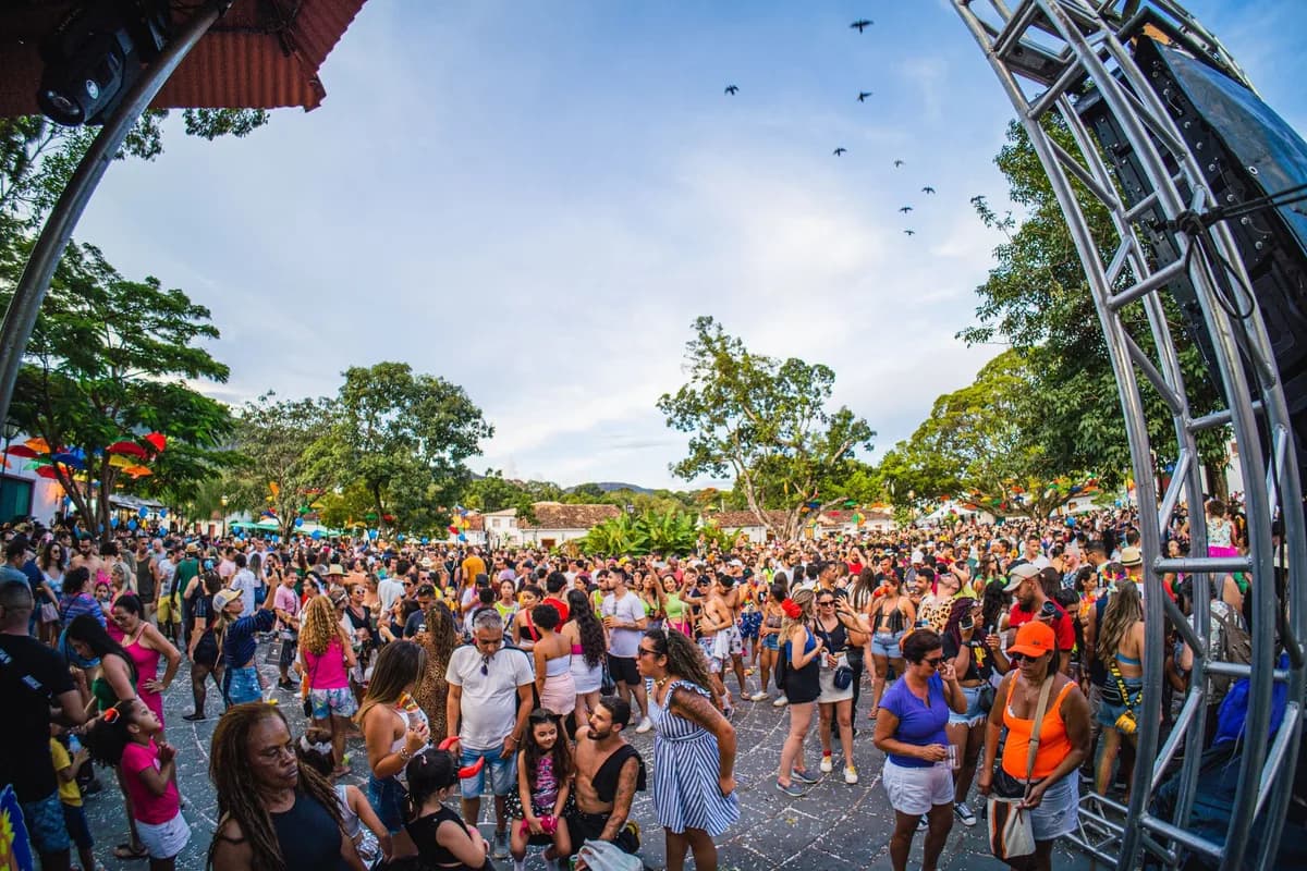A lively festival gathering in Tiradentes, Brazil, featuring a diverse crowd enjoying the outdoor event.