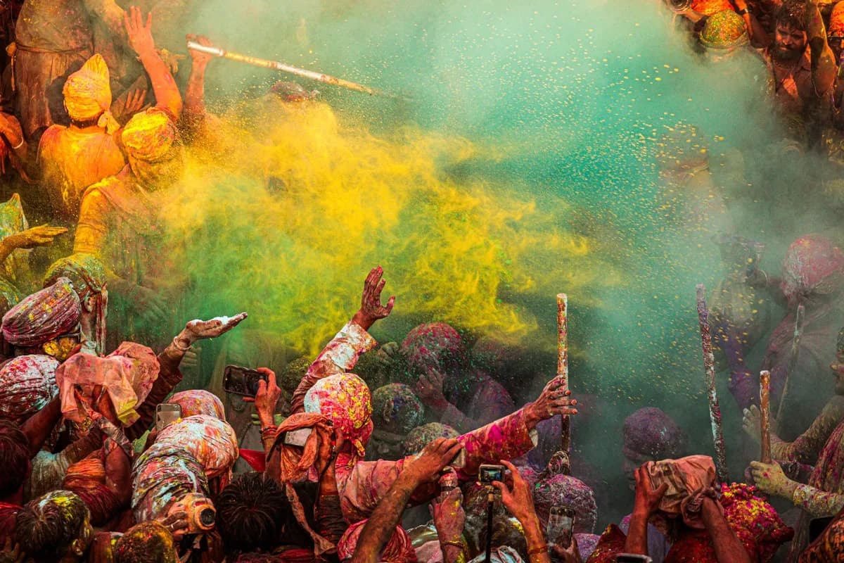 Colorful Holi festival in Mathura, India. People celebrate with vibrant powders and joy.