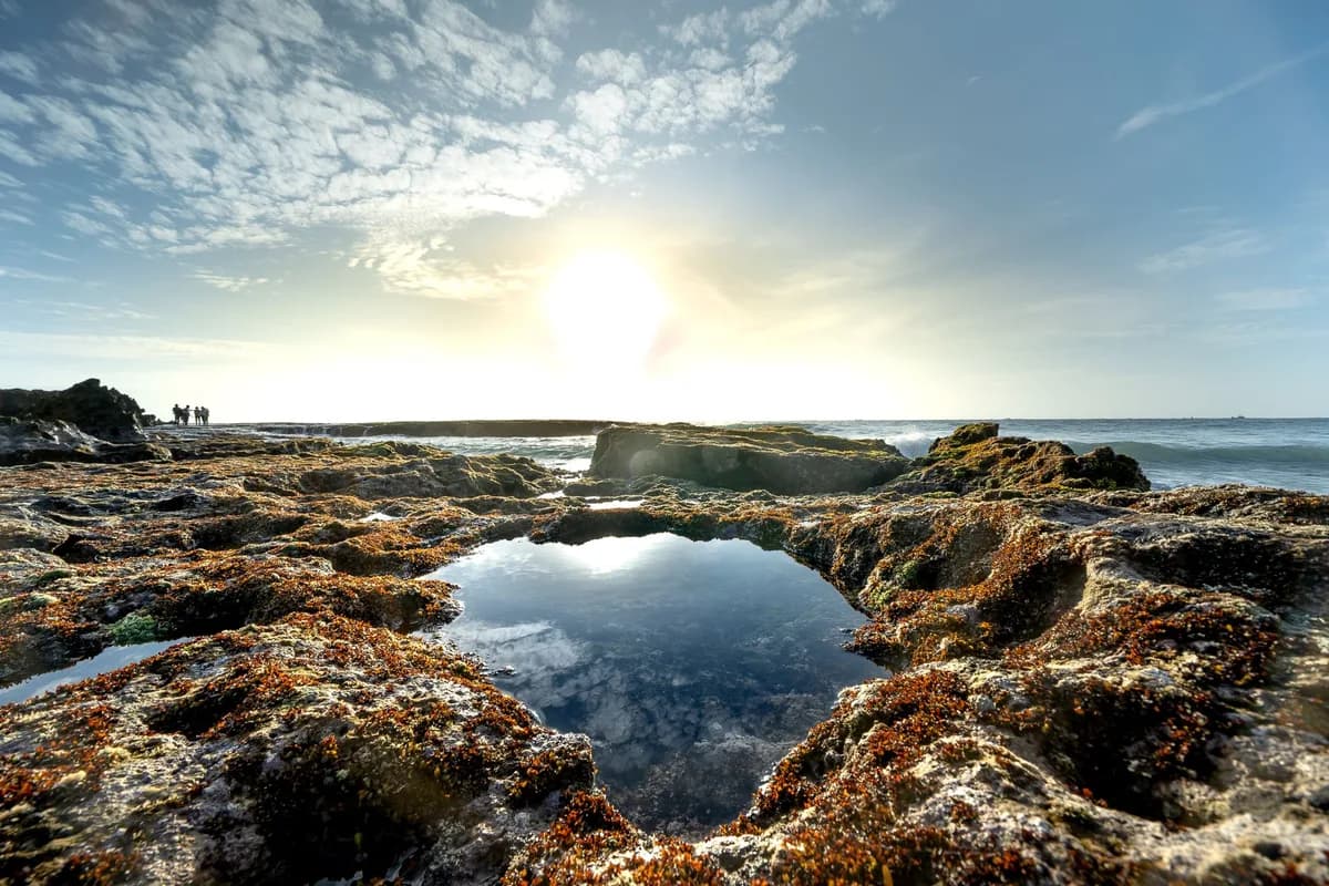 Stunning view of coastal rocks with vibrant sky at sunset.