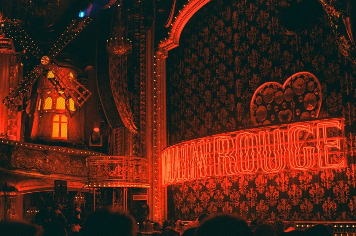 Captivating neon-lit interior of Moulin Rouge theater with iconic windmill in New York City.