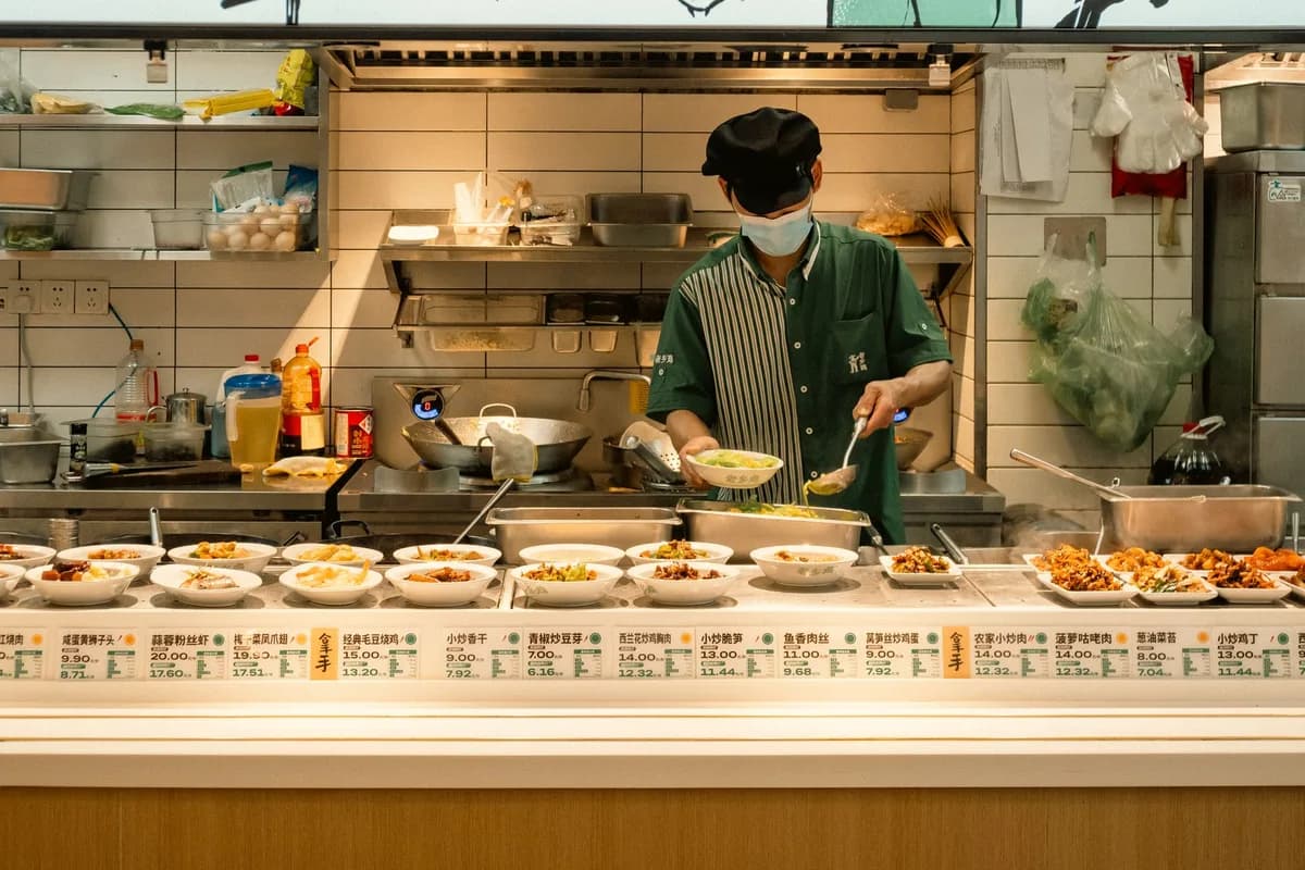A chef in Nanjing, China, prepares a variety of traditional dishes in a bustling kitchen.