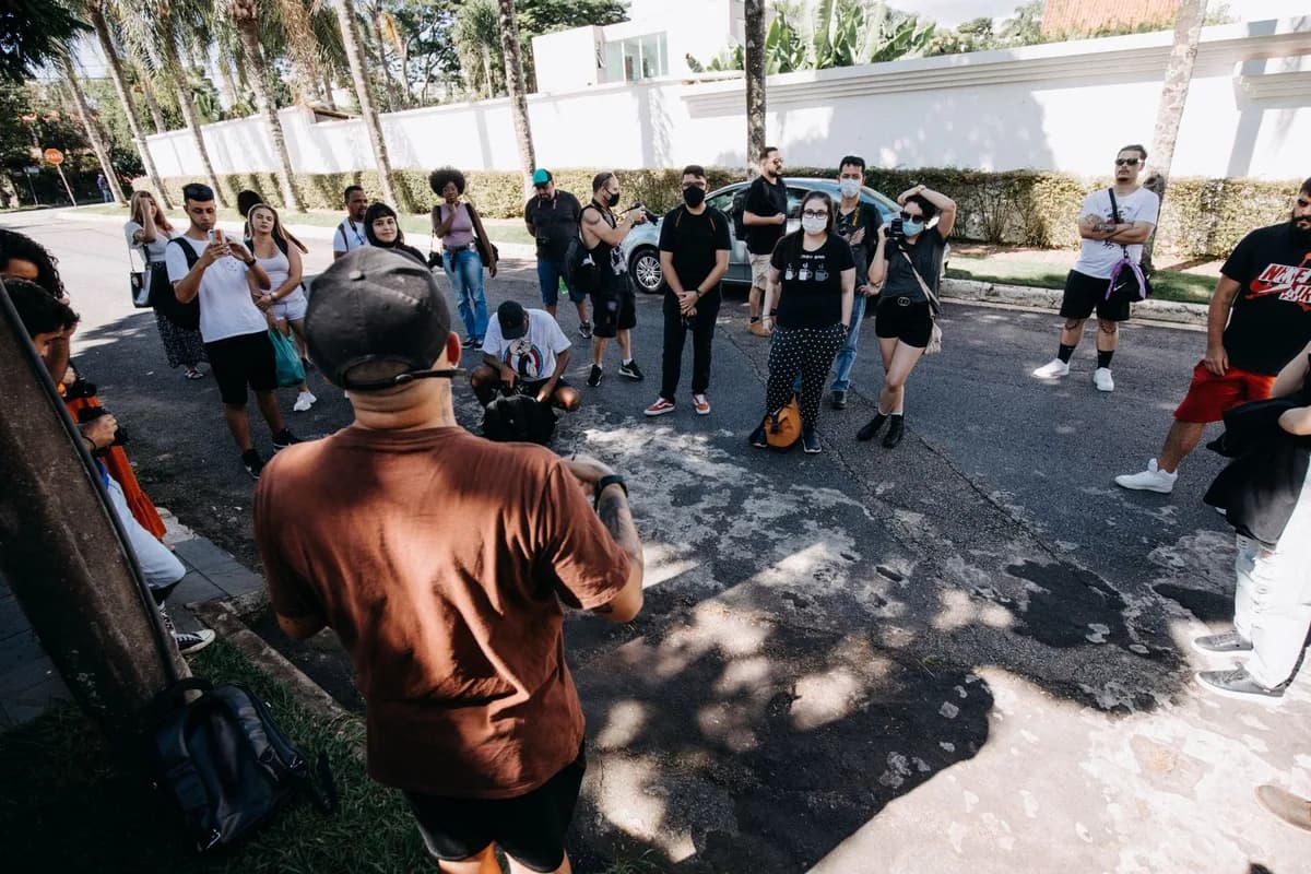 A diverse group of people on a guided tour during a sunny day on an urban street.