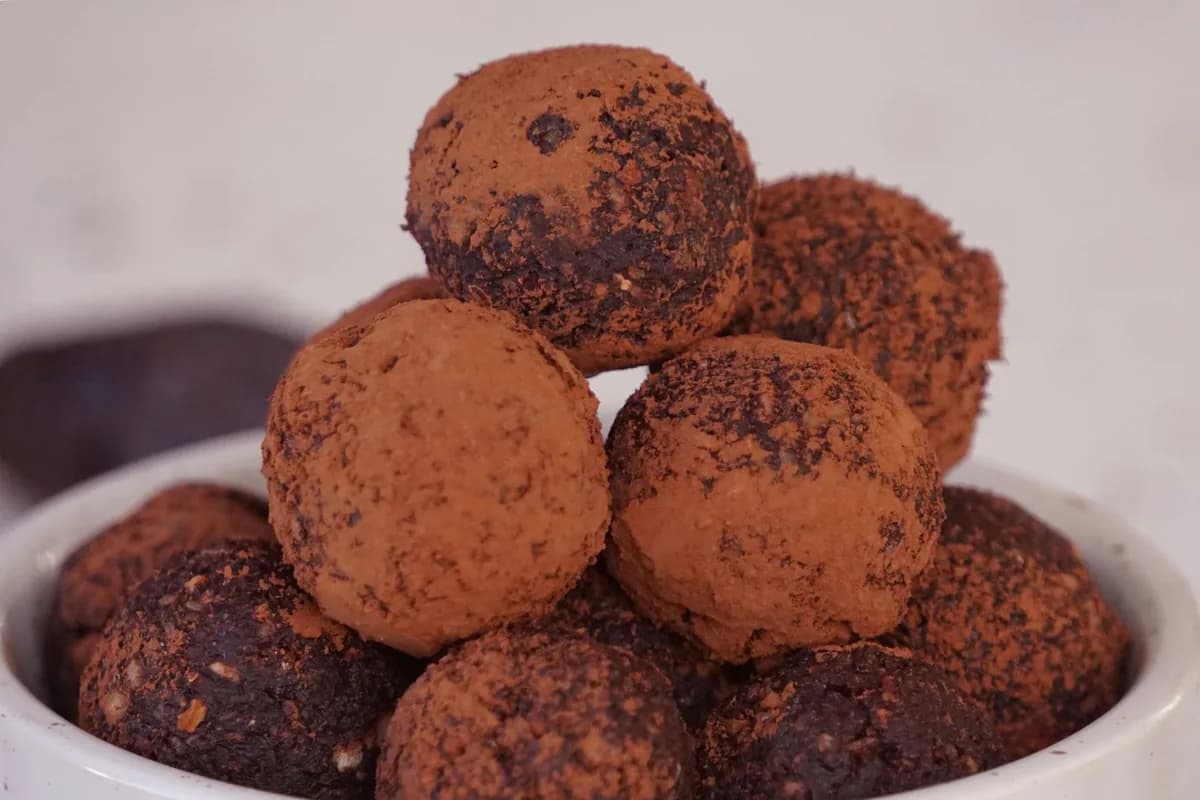 Indulgent homemade chocolate truffles coated with cacao for a sweet dessert treat.