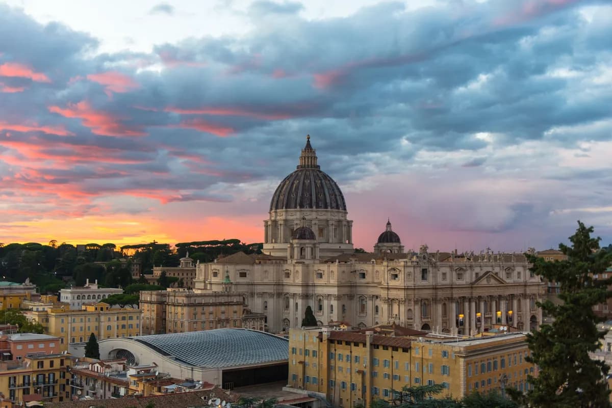 Beautiful view of St. Peter's Basilica at sunset with vibrant clouds in Vatican City.