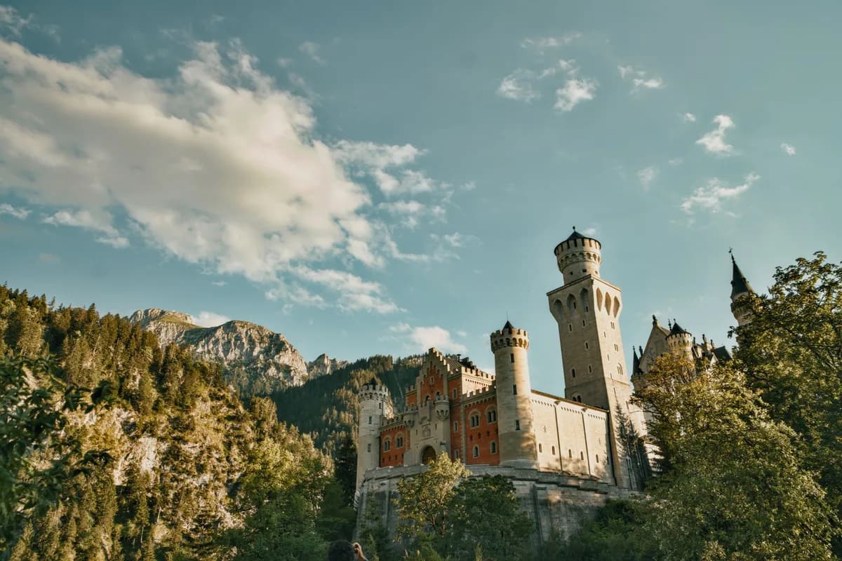 Majestic view of Neuschwanstein Castle in Bavaria, Germany, surrounded by lush green forests.