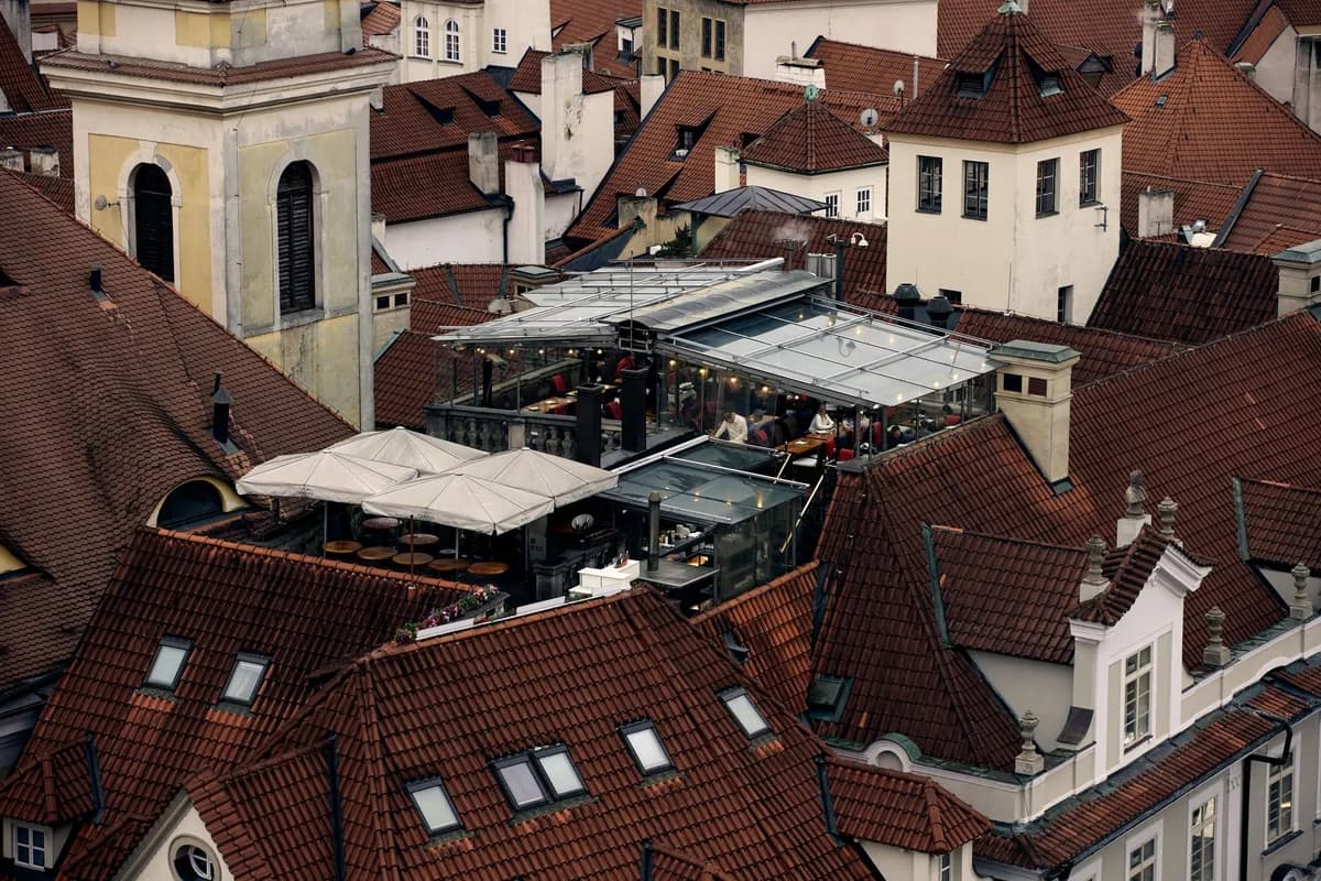 Charming rooftop restaurant on terracotta rooftops in an historic European city.