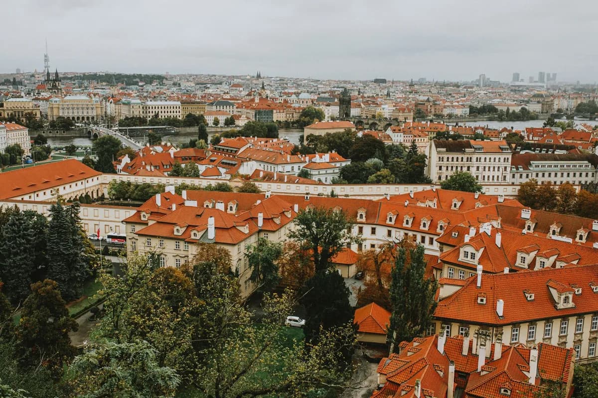 Explore the charming red rooftops and historic architecture of Prague in this captivating aerial photograph.