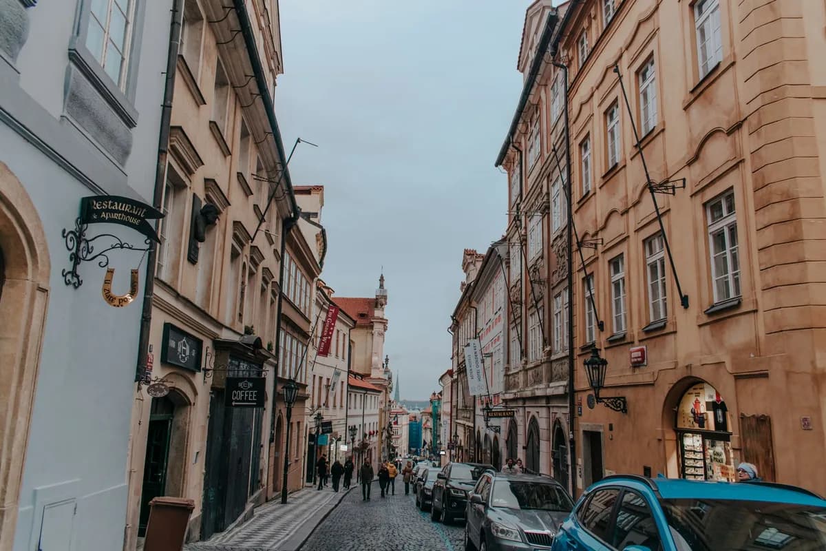 Explore the charm of a historic Prague street with classic architecture and cobblestones.