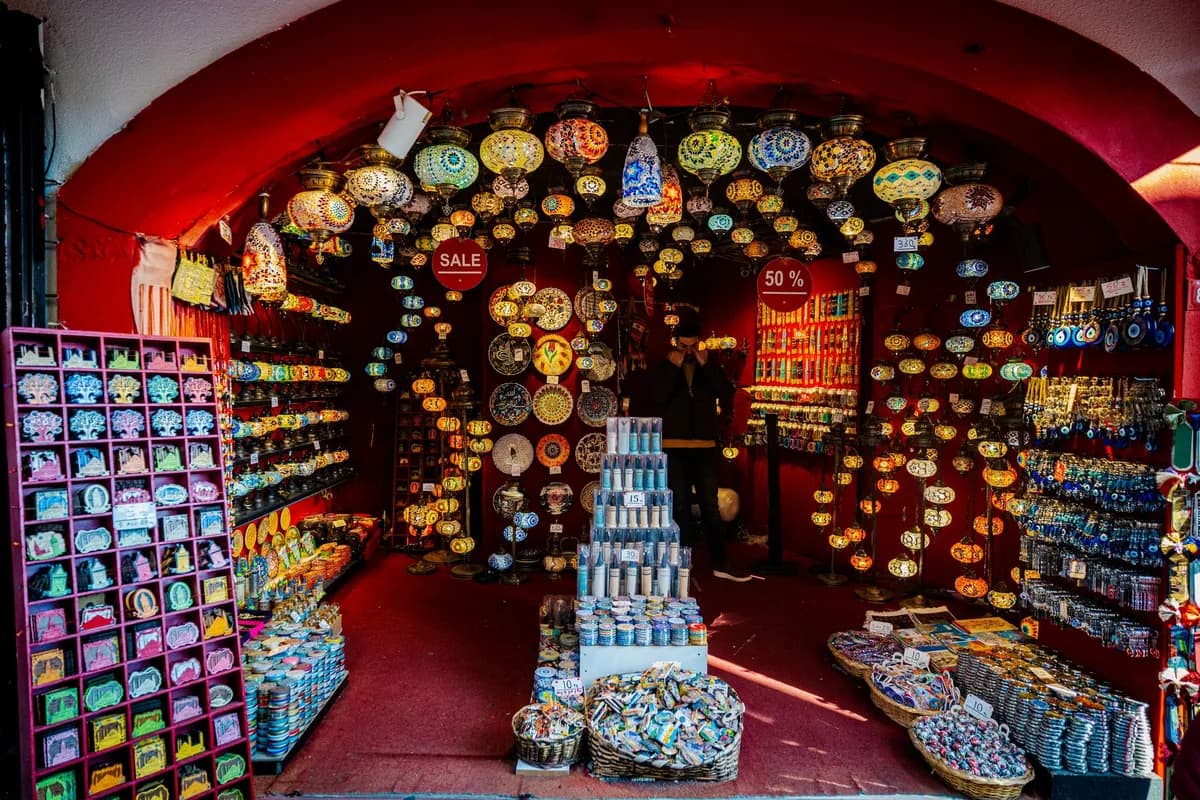 Explore a bustling Istanbul bazaar full of vibrant lanterns and unique Turkish souvenirs.