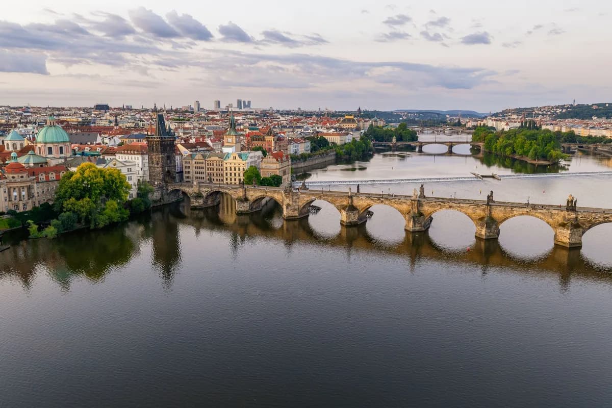Stunning aerial shot of Charles Bridge over the Vltava River in Prague, showcasing historical architecture.