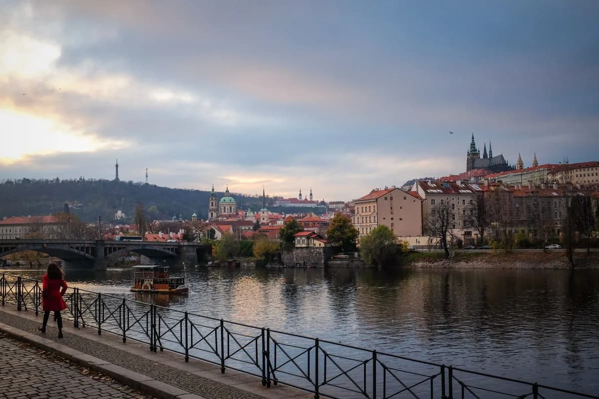 Stunning view of Prague's cityscape featuring Charles Bridge and Prague Castle during a serene twilight moment.