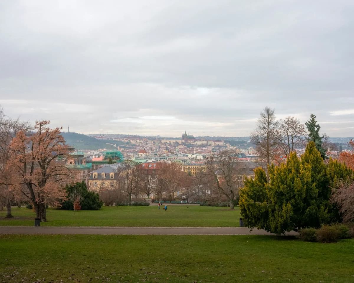 Scenic view of Prague's skyline captured from Letná Park during a cloudy day in autumn.