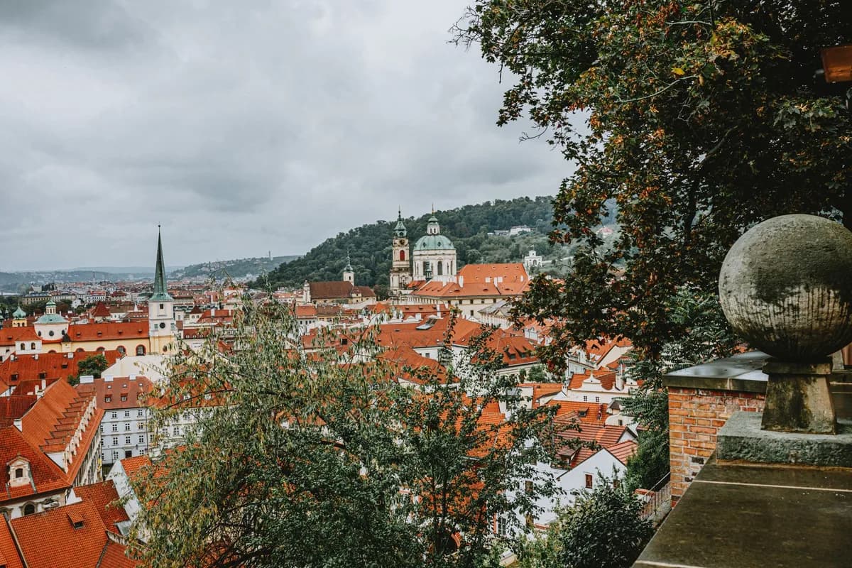 Explore the stunning skyline of Prague with red rooftops and historical architecture.